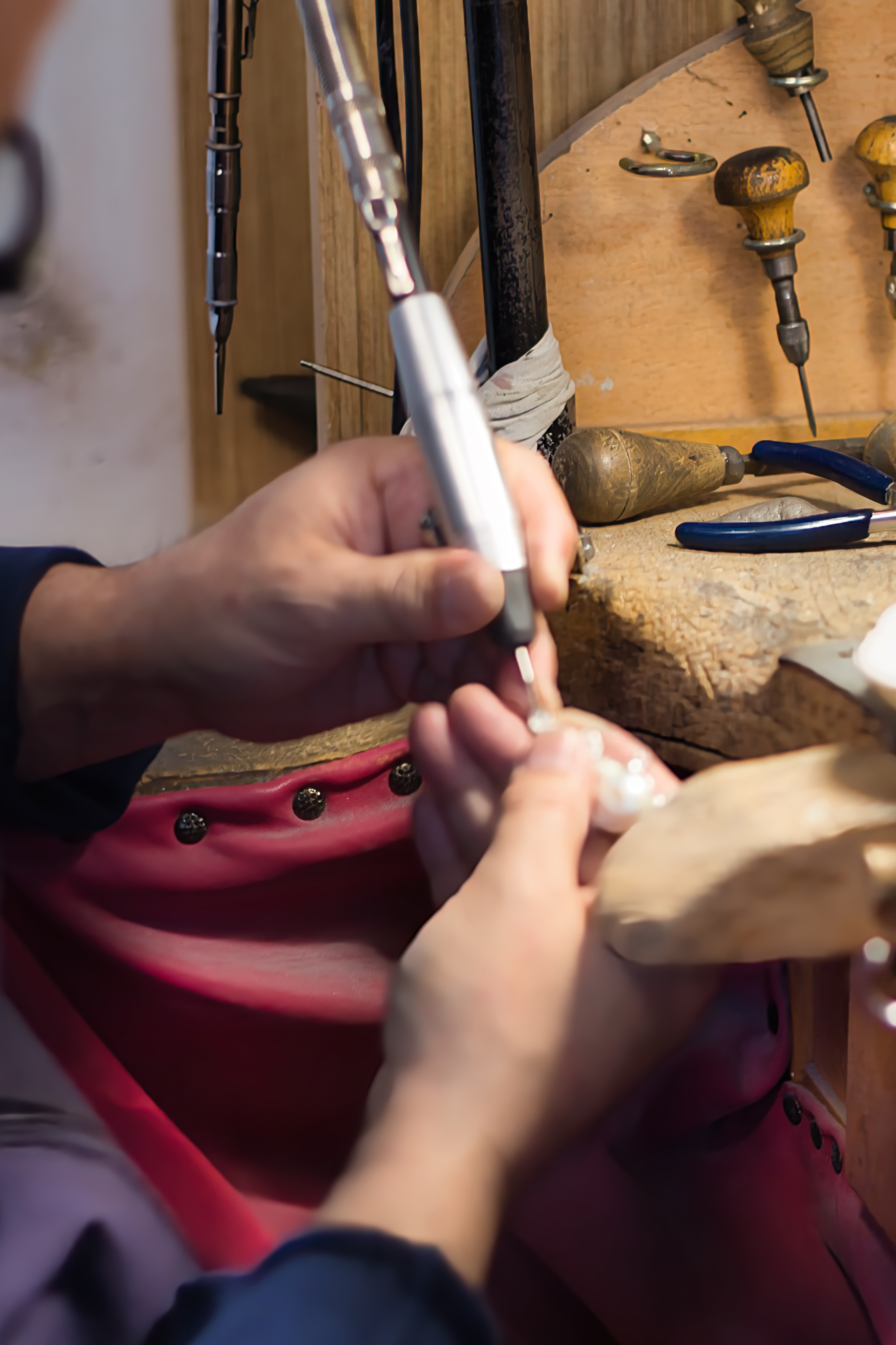 A master silversmith shaping a piece by hand